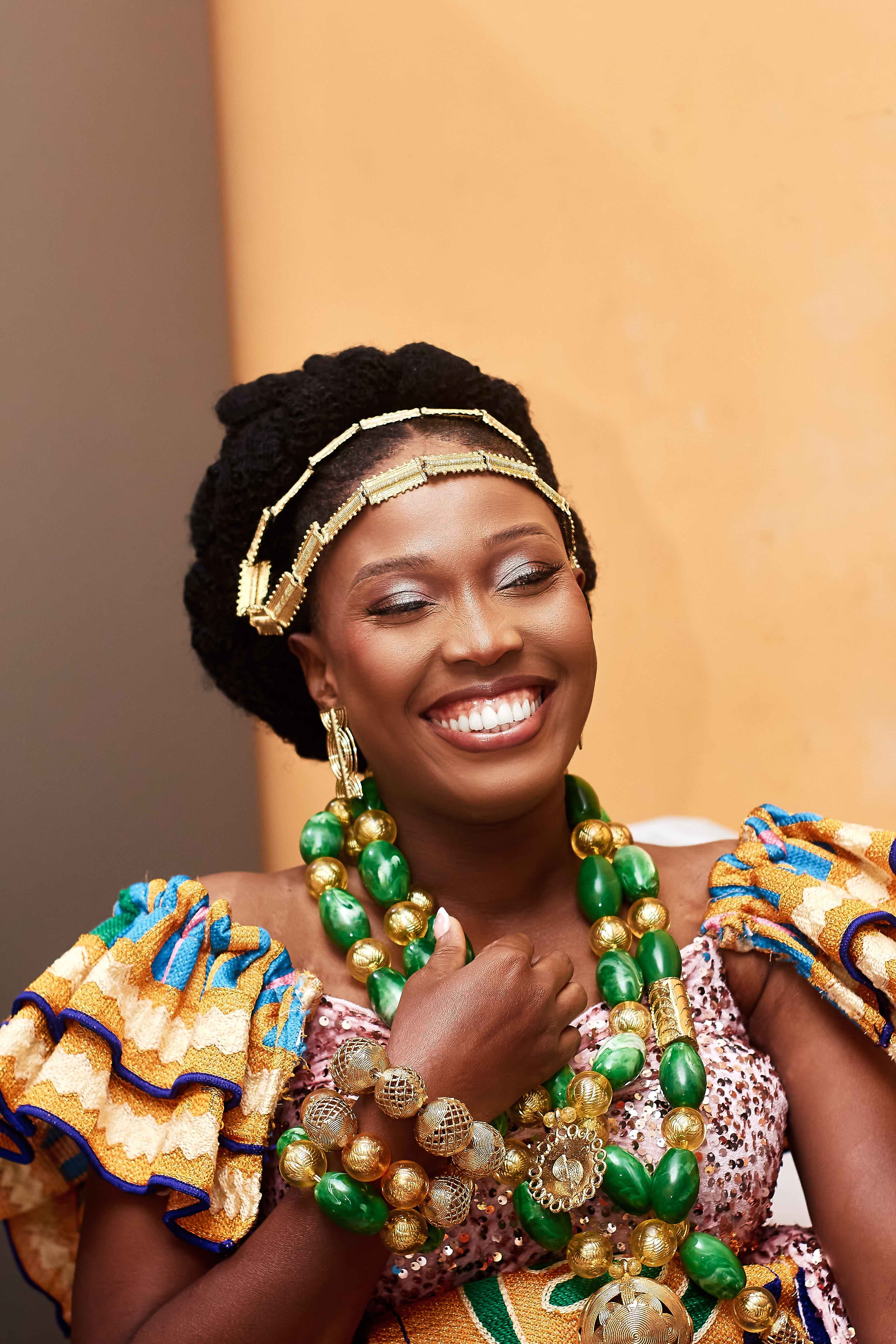 Portrait souriant de la mariée en parures vertes et dorées
